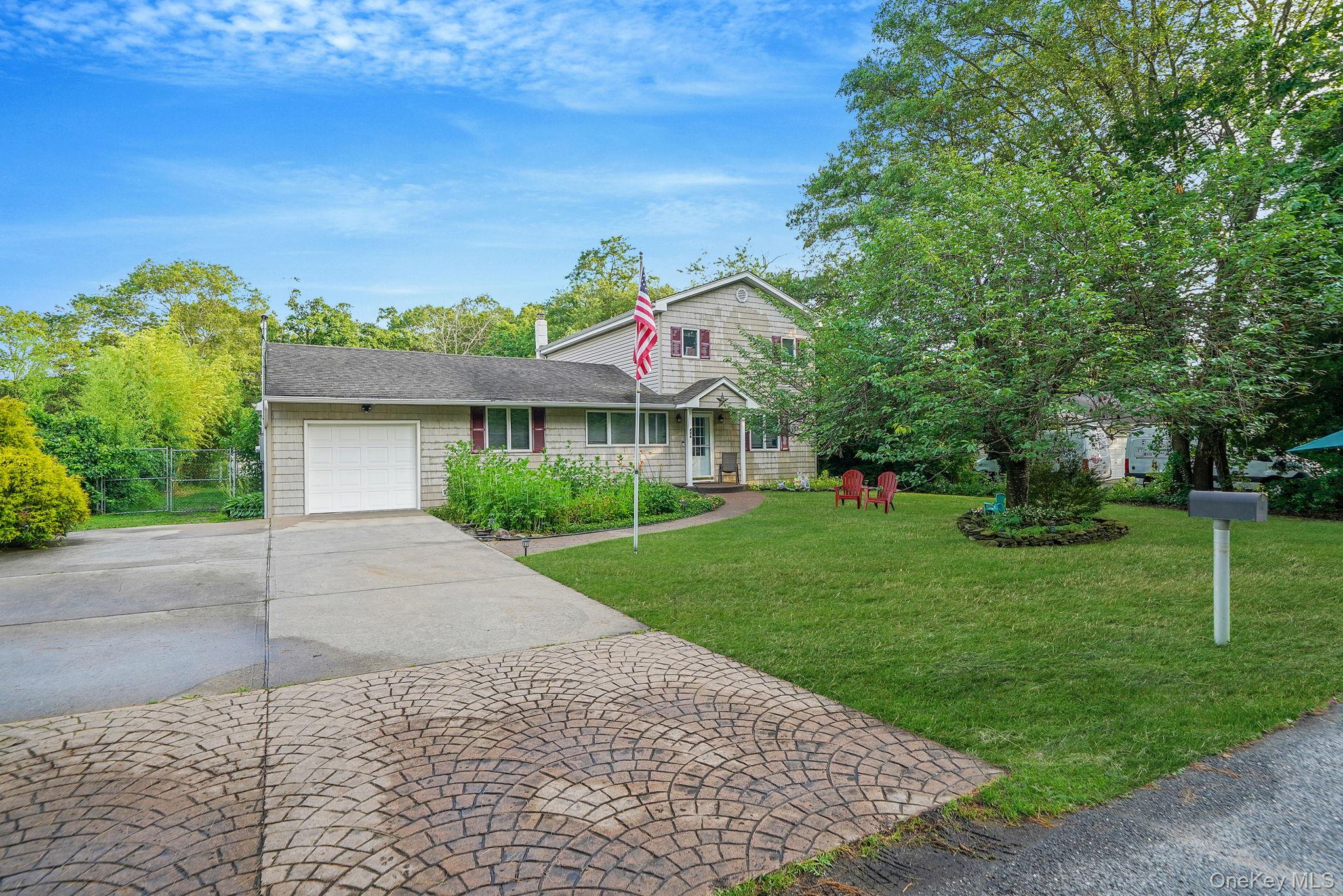 View of front of home with a garage and concrete driveway