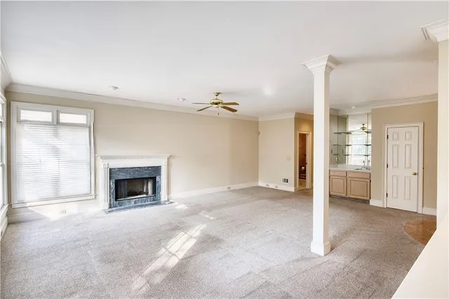 a view of empty room with a kitchen and a fireplace
