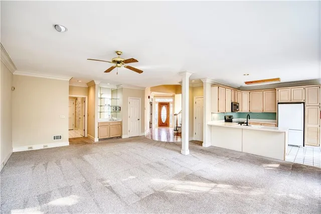 a view of a kitchen with a sink and a refrigerator
