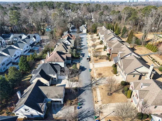 an aerial view of multiple houses with a yard