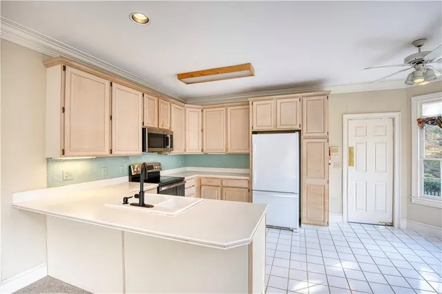 a kitchen with a sink appliances and cabinets