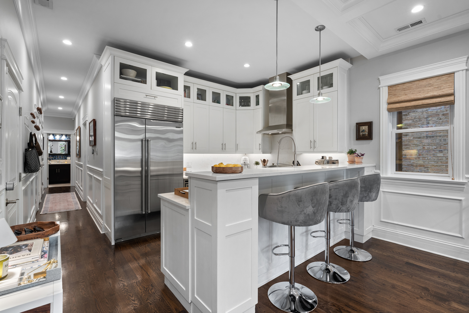 2680 North Orchard Street, Unit 2 Chicago, IL 60614 - Photo 14 of 27 a kitchen with stainless steel appliances kitchen island granite countertop a sink cabinets and wooden floor