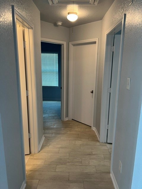 18303 Ranch View Trail Houston, TX 77073 - Photo 8 of 19 Bright hallway with light tile flooring, leading to multiple rooms with modern white doors and a cozy ambiance.
