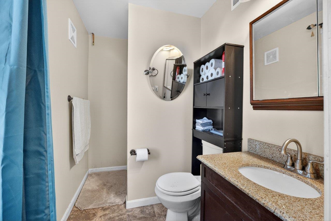 724 Newtown Road Elkton, VA 22827 - Photo 28 of 38 a bathroom with a granite countertop sink and a toilet
