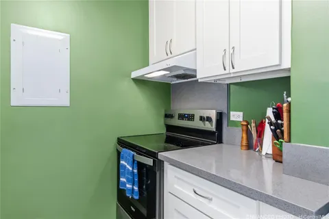 a kitchen with stainless steel appliances granite countertop a sink and a stove