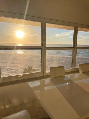 a living room with couches chairs and fireplace with wooden floor