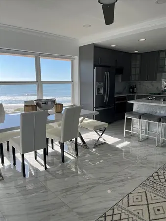a view of a dining room with furniture and window