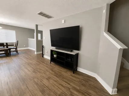 a living room with furniture and flat screen tv