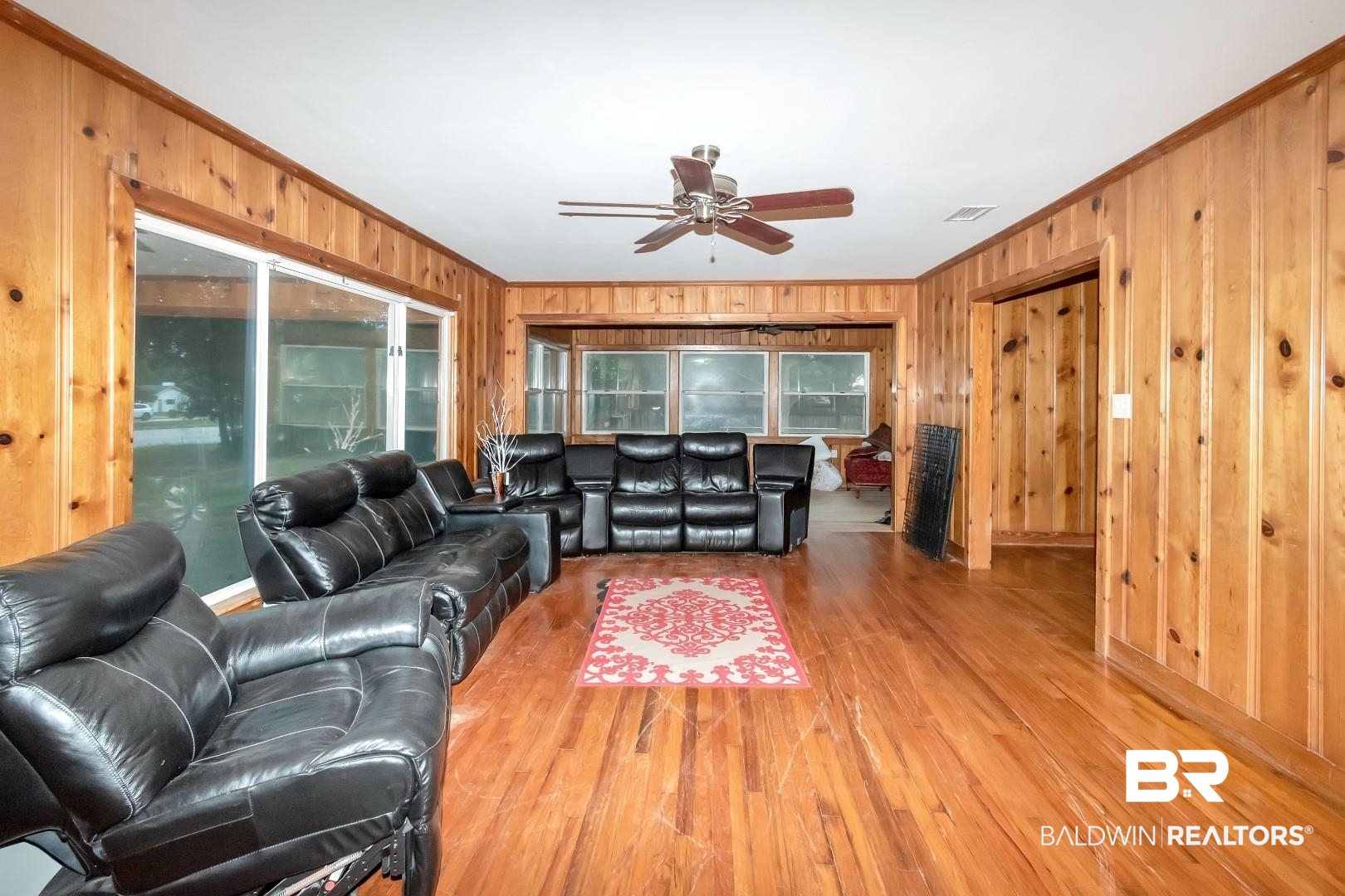 2762 Hillcrest Road Mobile, AL 36695 - Photo 7 of 25 Living room featuring hardwood / wood-style floors, wood walls, ceiling fan, and crown molding