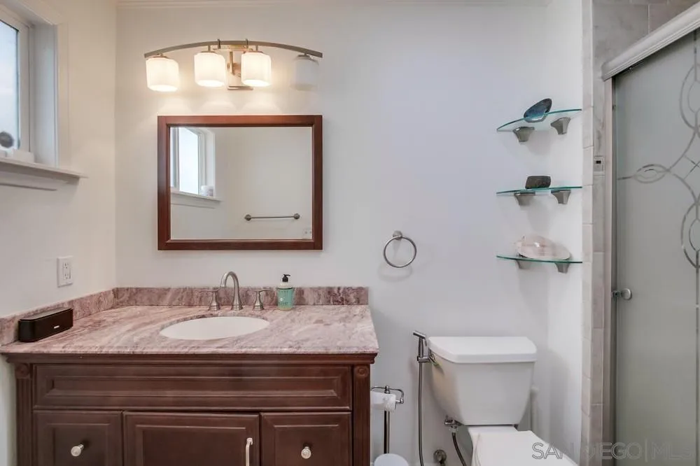10520 El Nopal Santee, CA 92071 - Photo 11 of 34 a bathroom with a granite countertop toilet a sink and mirror