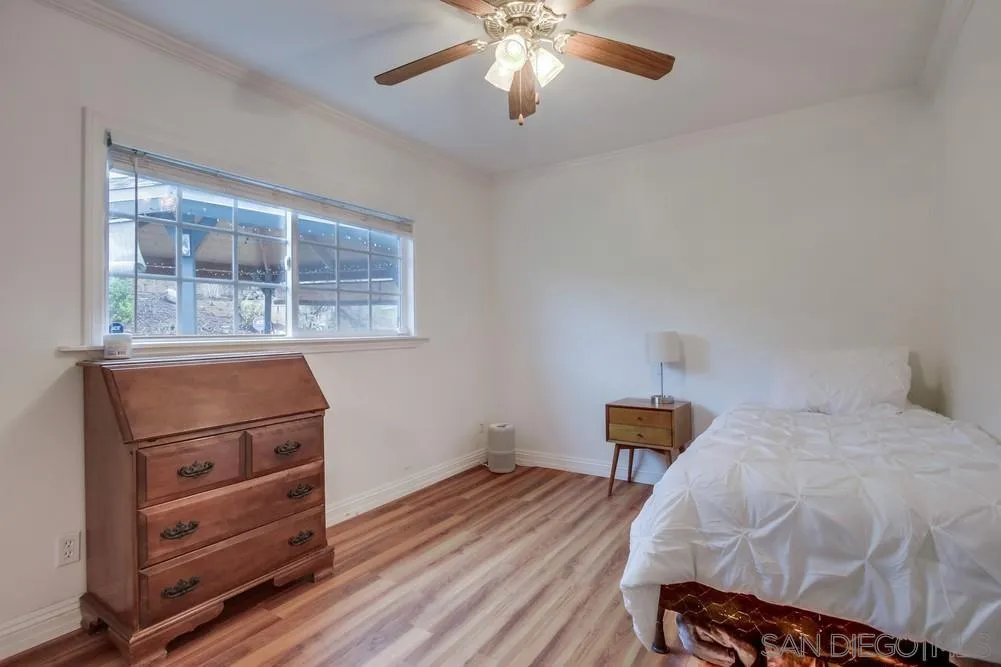 10520 El Nopal Santee, CA 92071 - Photo 14 of 34 a bedroom with a bed and wooden floor