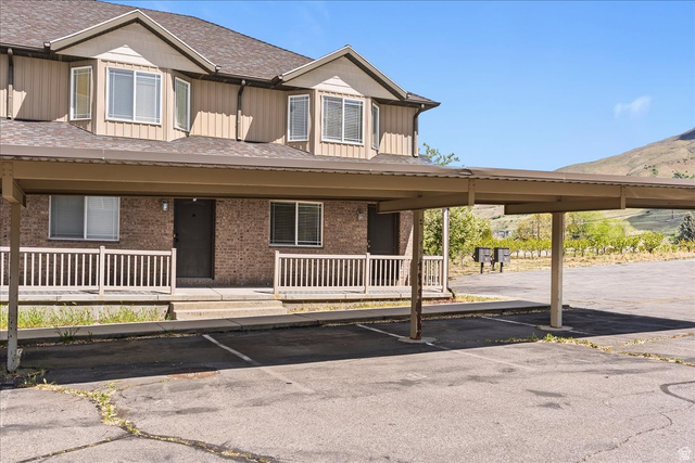 2350 South Highway 89, Unit 4 Perry, UT 84302 - Photo 2 of 30 View of front of home with board and batten siding, covered porch, and covered parking