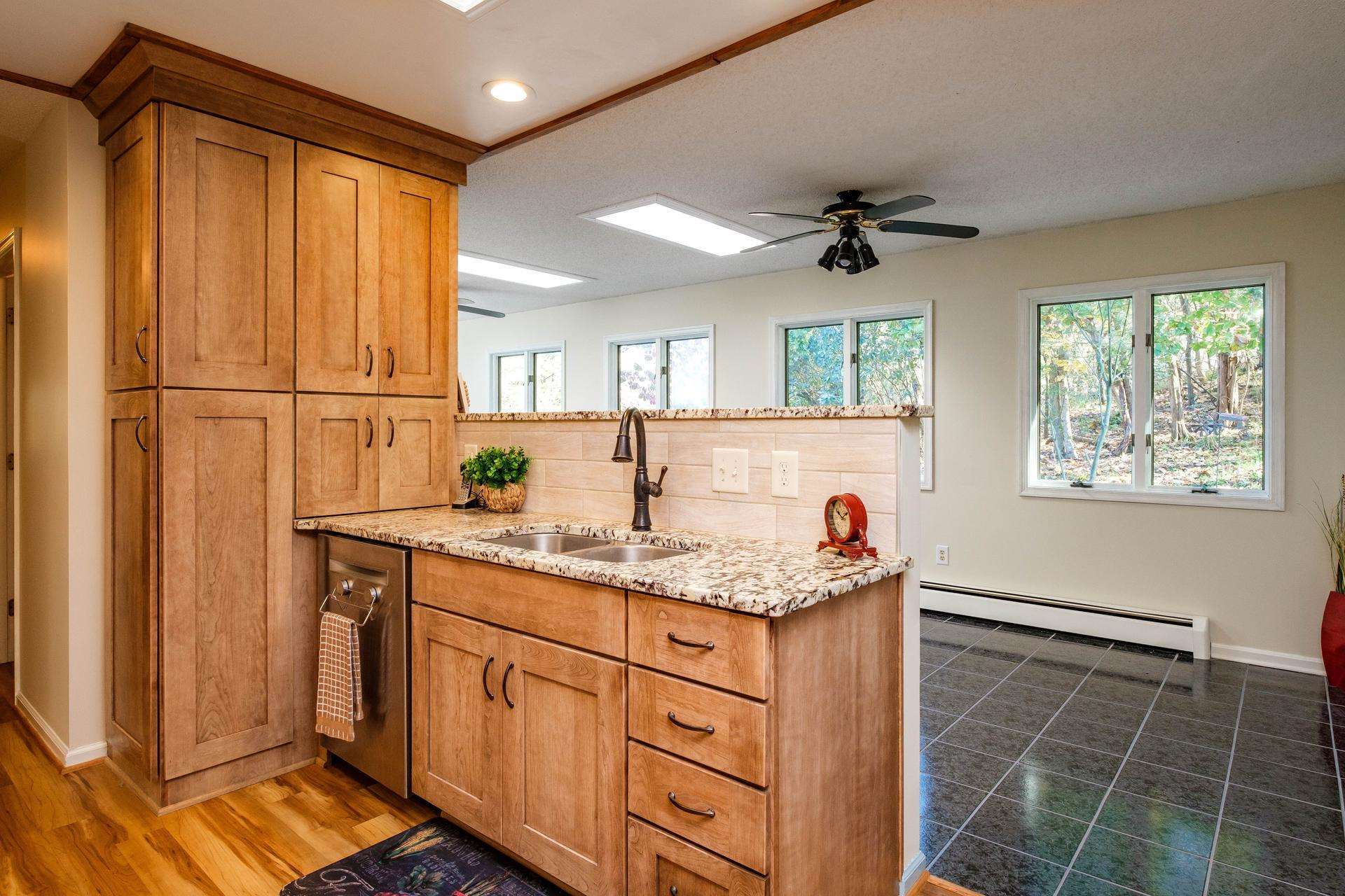 3878 Shutterlee Mill Road Staunton, VA 24401 - Photo 4 of 63 a kitchen with kitchen island granite countertop a sink stainless steel appliances cabinets and a counter top space