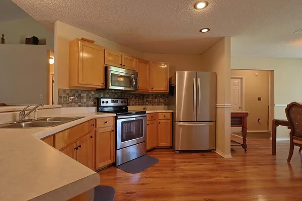 a kitchen with a sink cabinets and stainless steel appliances