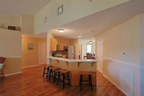 a view of a dining room with furniture and wooden floor