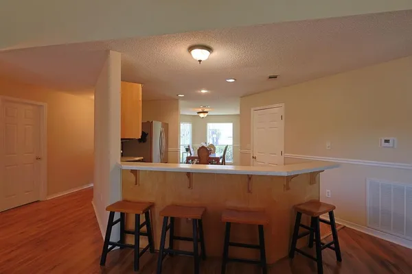 a dining room with furniture and wooden floor