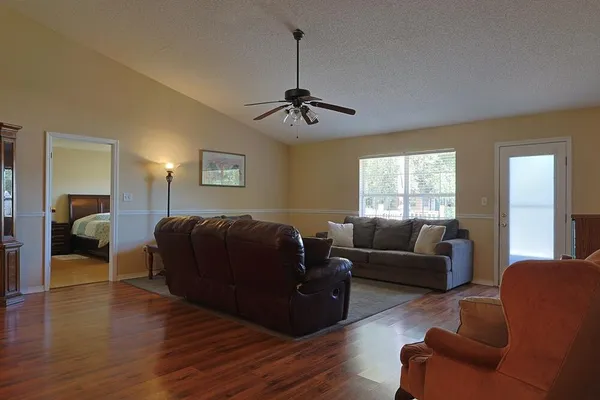 a living room with furniture window and wooden floor
