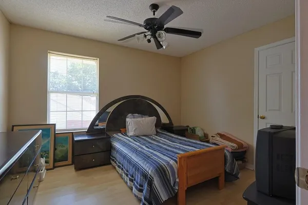 a bedroom with a bed and a window