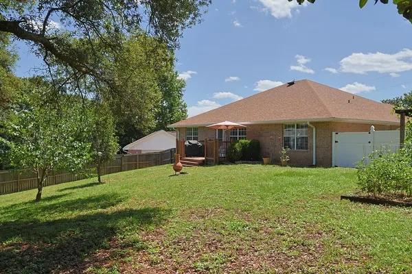 a view of a house with a backyard