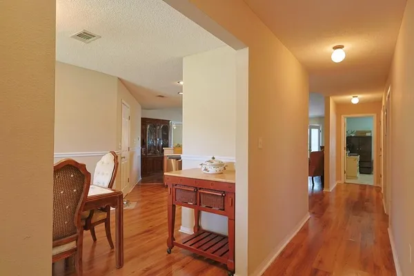 a dining room with furniture and wooden floor