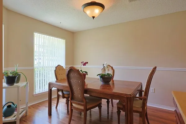 a view of a dining room with furniture and wooden floor
