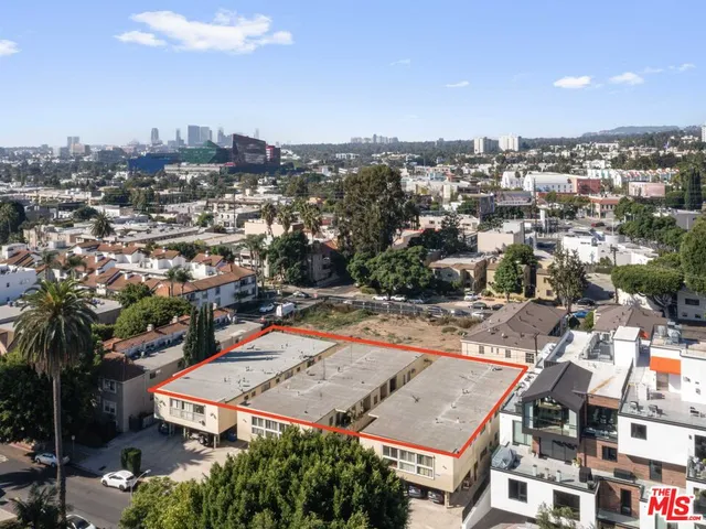 an aerial view of residential houses with city view