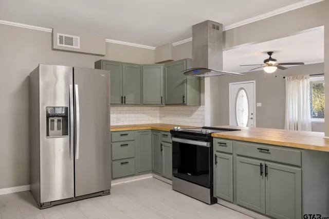 a kitchen with cabinets and stainless steel appliances