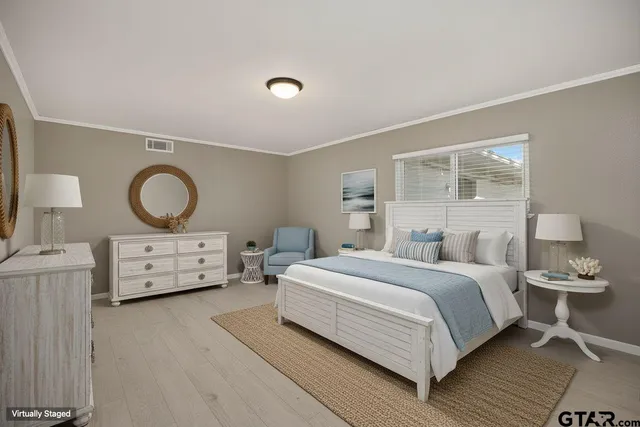 a bedroom with a bed and dresser with mirror