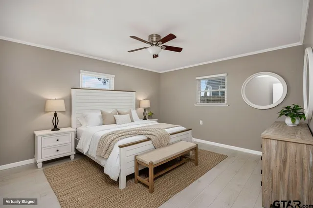 a bedroom with bed and a chandelier