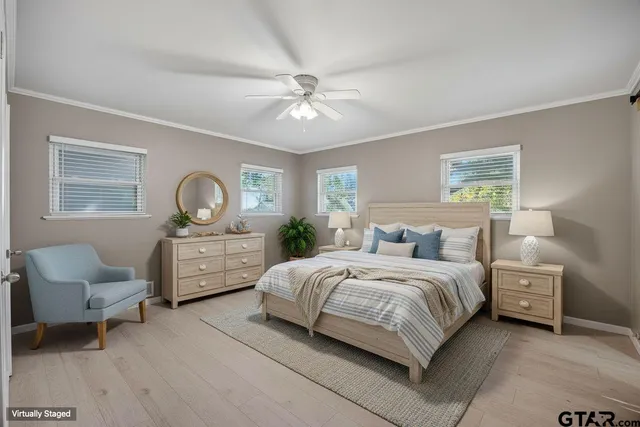 a view of a big room with closet and a chandelier fan