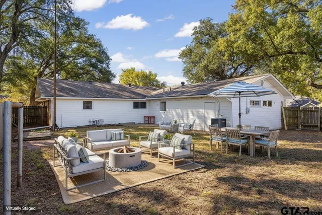 a view of a backyard with wooden fence