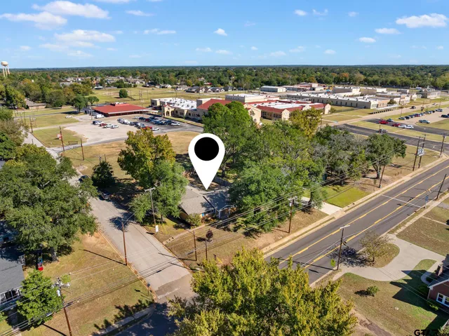 an aerial view of a house with yard swimming pool and outdoor seating
