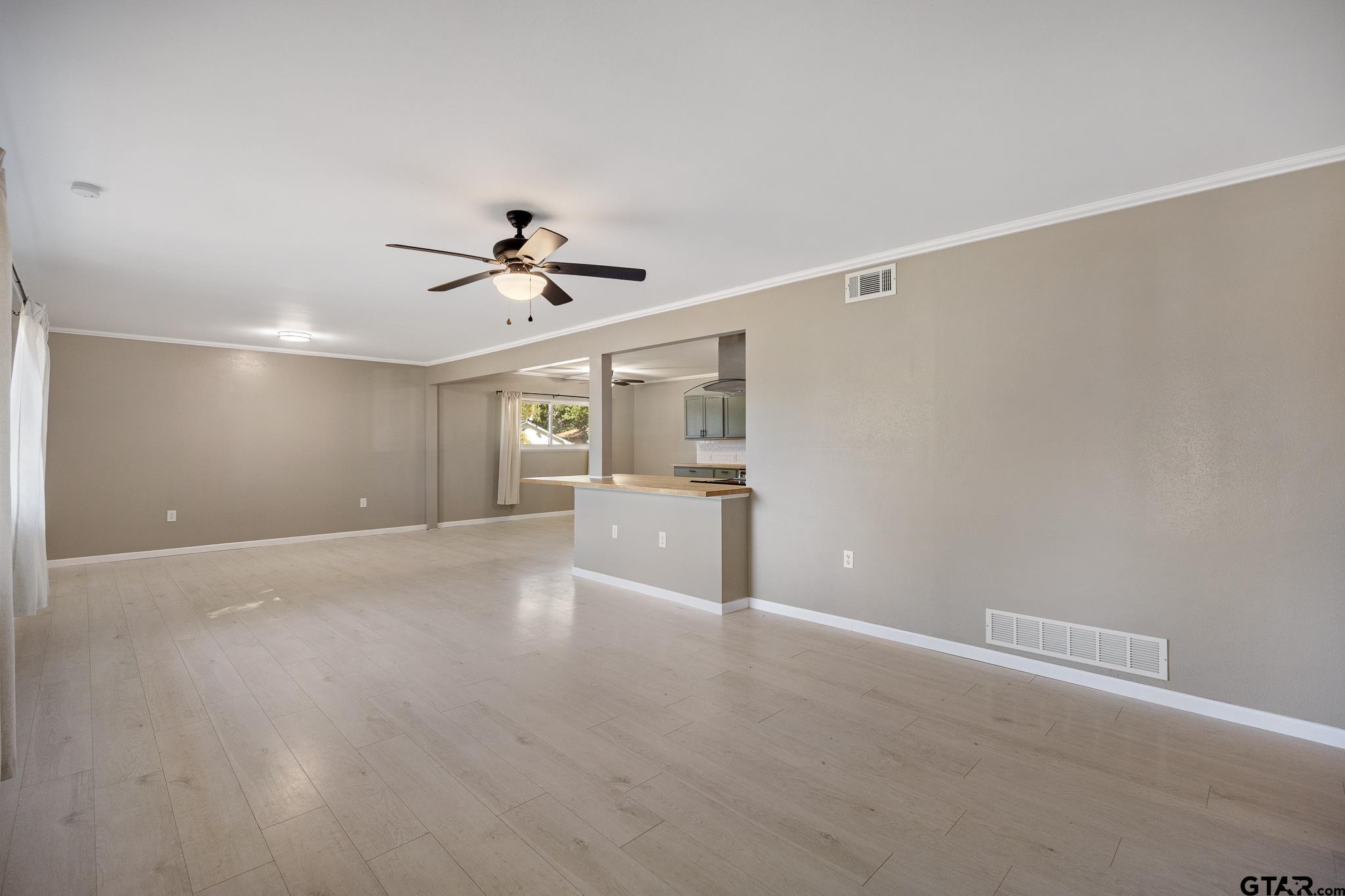 291 East Main Street Van, TX 75790 - Photo 4 of 37 a view of an empty room with a ceiling fan and window