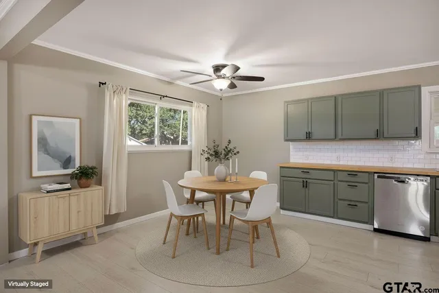 a kitchen with granite countertop a sink cabinets and appliances