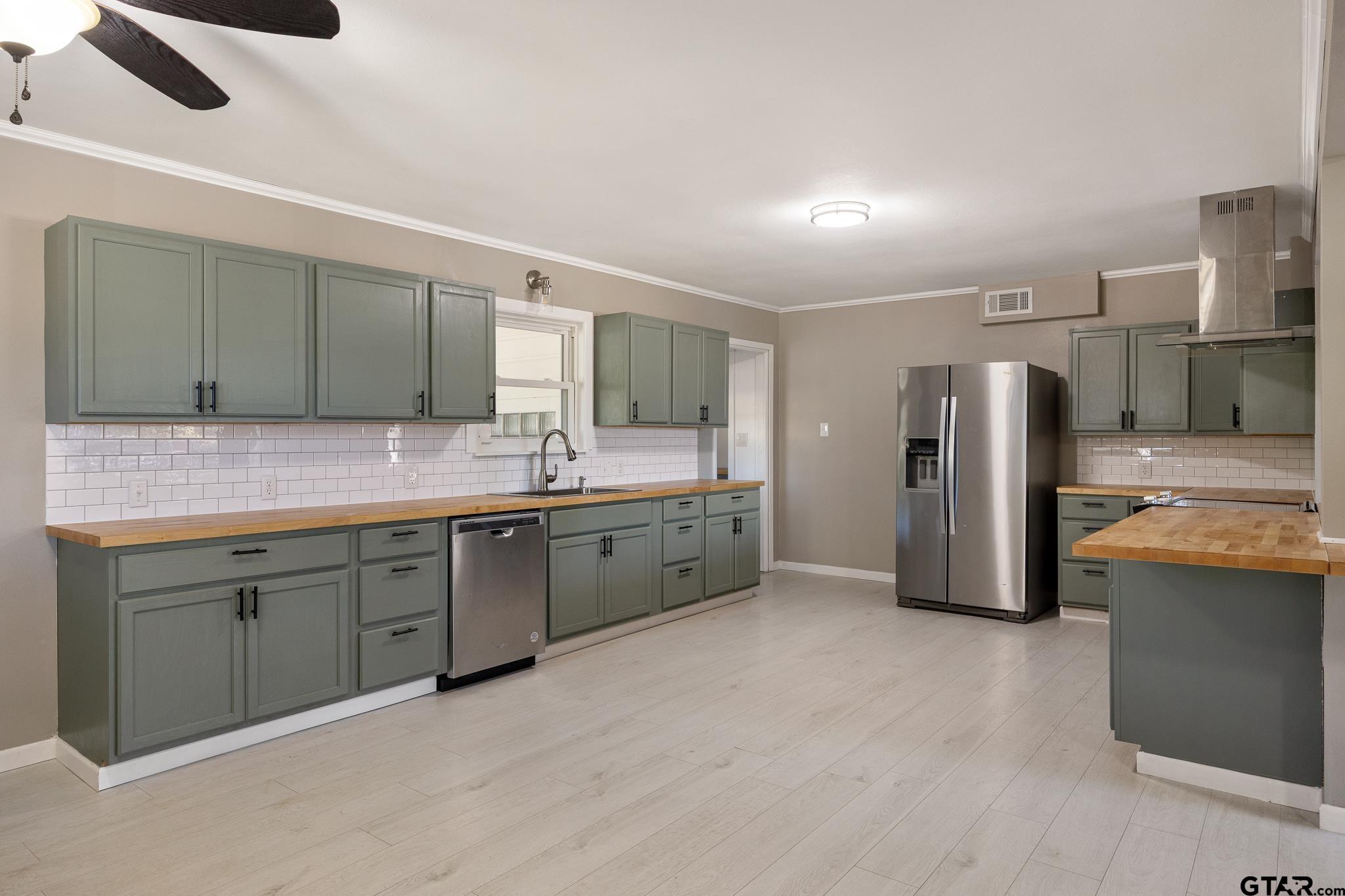 291 East Main Street Van, TX 75790 - Photo 7 of 37 a large kitchen with a sink and stainless steel appliances