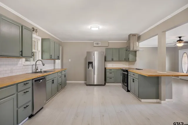 a large kitchen with cabinets and stainless steel appliances