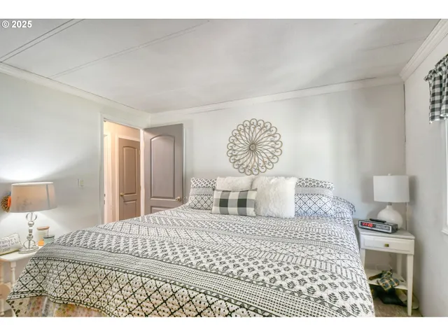 a bedroom with a large bed and a lamp