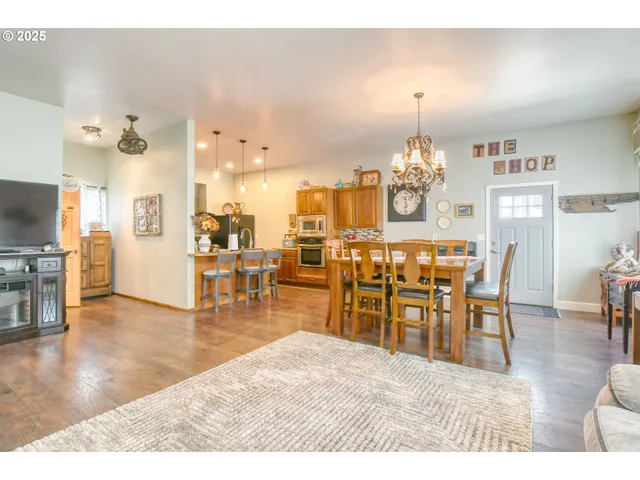 a dining room filled with furniture and wooden floor