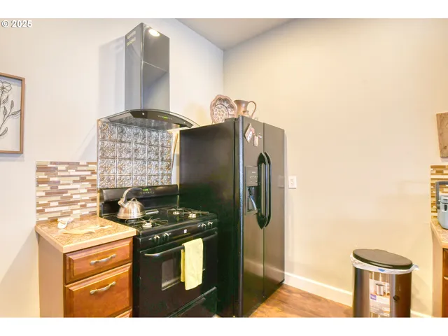 a kitchen with stainless steel appliances granite countertop a stove and a refrigerator