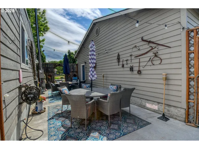 a view of a patio with table and chairs and potted plants