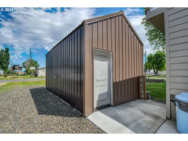 a view of backyard with cabin