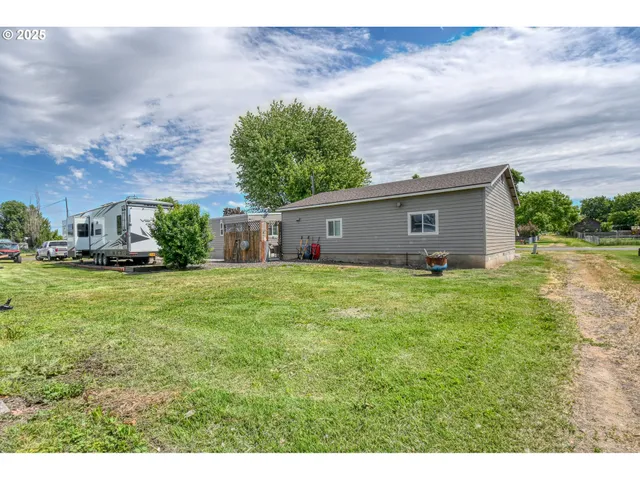 a front view of house with a garden