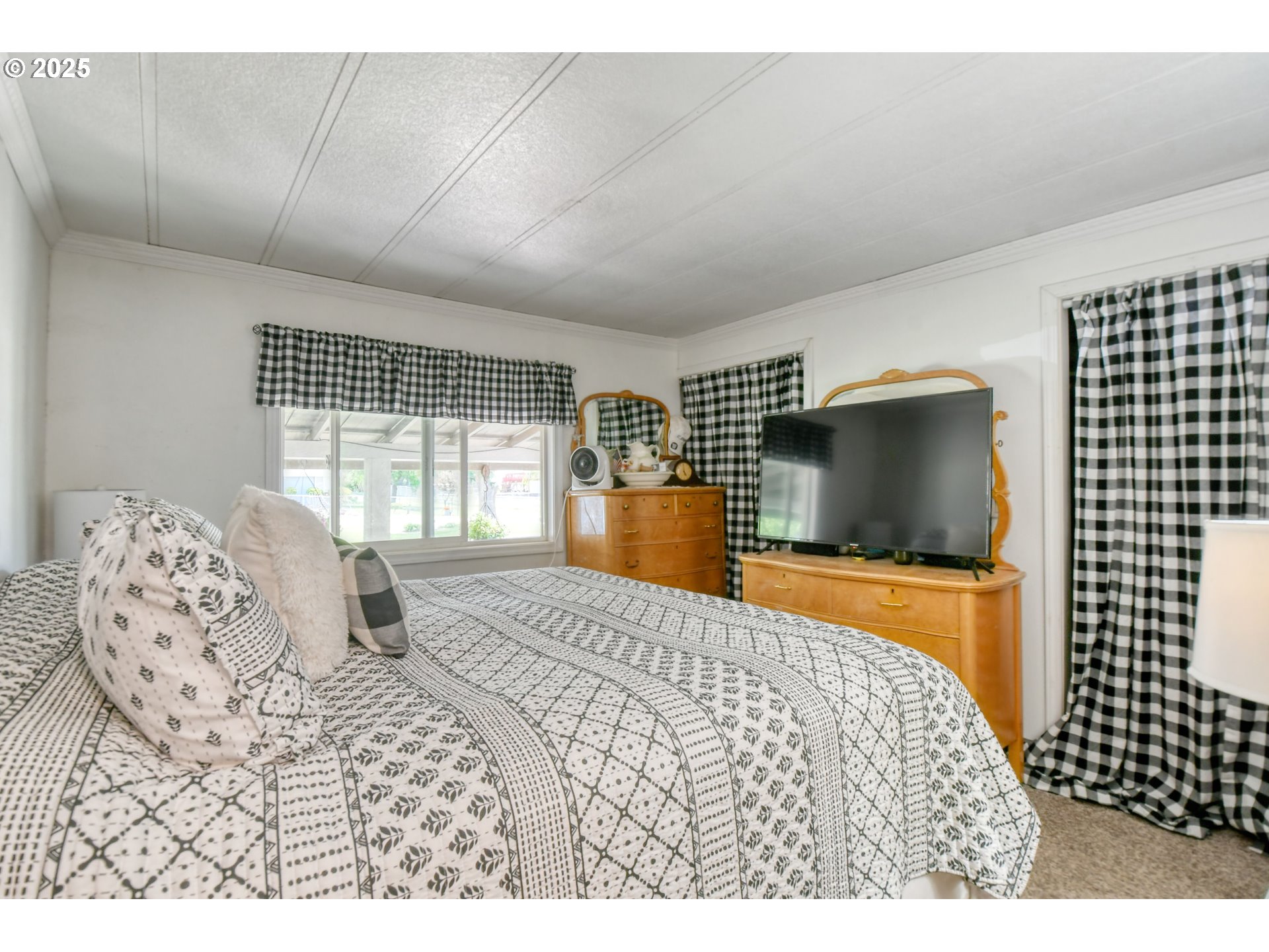 330 2nd Street Athena, OR 97813 - Photo 10 of 30 a bedroom with a large bed and a flat tv screen on dresser