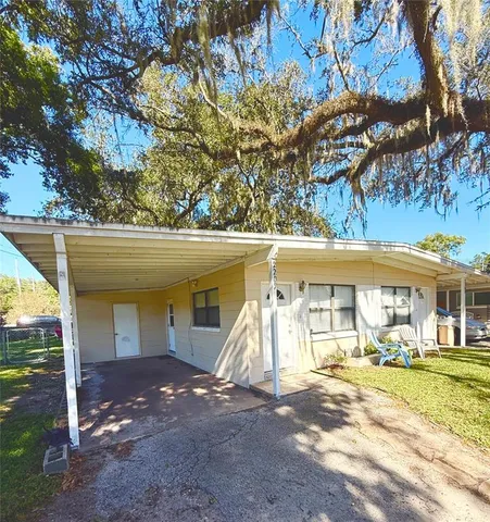 a view of a house with a yard and garage
