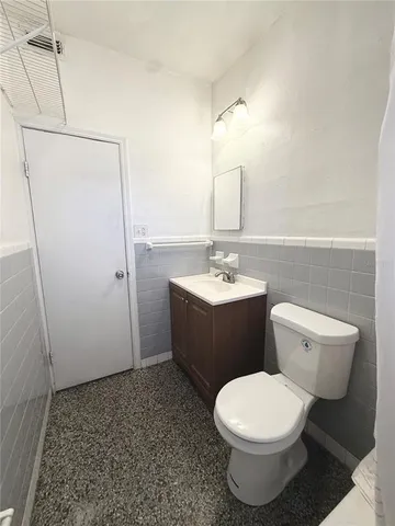 an empty room with a ceiling fan and window