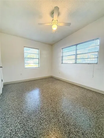 an empty room with a empty space and windows