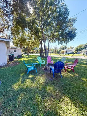 a view of a house with backyard and sitting area