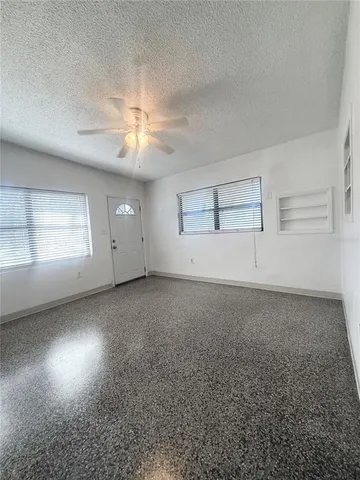 an empty room with a empty space and windows