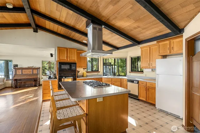 a kitchen with stainless steel appliances granite countertop a stove and a refrigerator