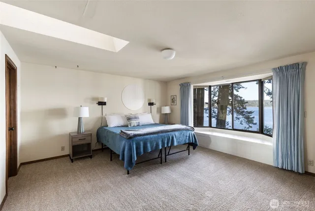 a bedroom with a large bed and a flat screen tv